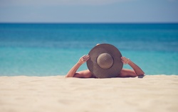 Woman Wearing a Hat on the Beach