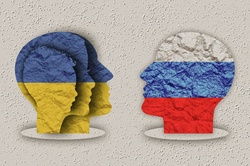 Heads on flags of Ukraine and Russia