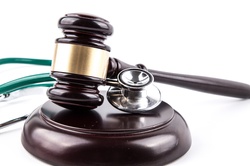 Concept about medical lawsuit, stethoscope and gavel on white background