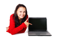 Young woman pointing at computer isolated on white background 