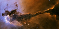 A gigantic fairy might be imagined in this NASA photo of one of Eagle Nebula striking dust pillars