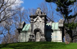 Victorian cemetery mausoleum marred by graffiti.