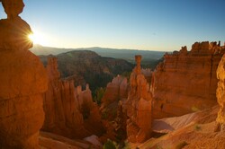 Sun rises over the tall orange rock formations of Bryce Canyon National Park in southern Utah.