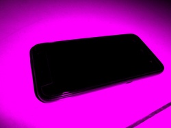 Android mobile cell phone with pink coloured background