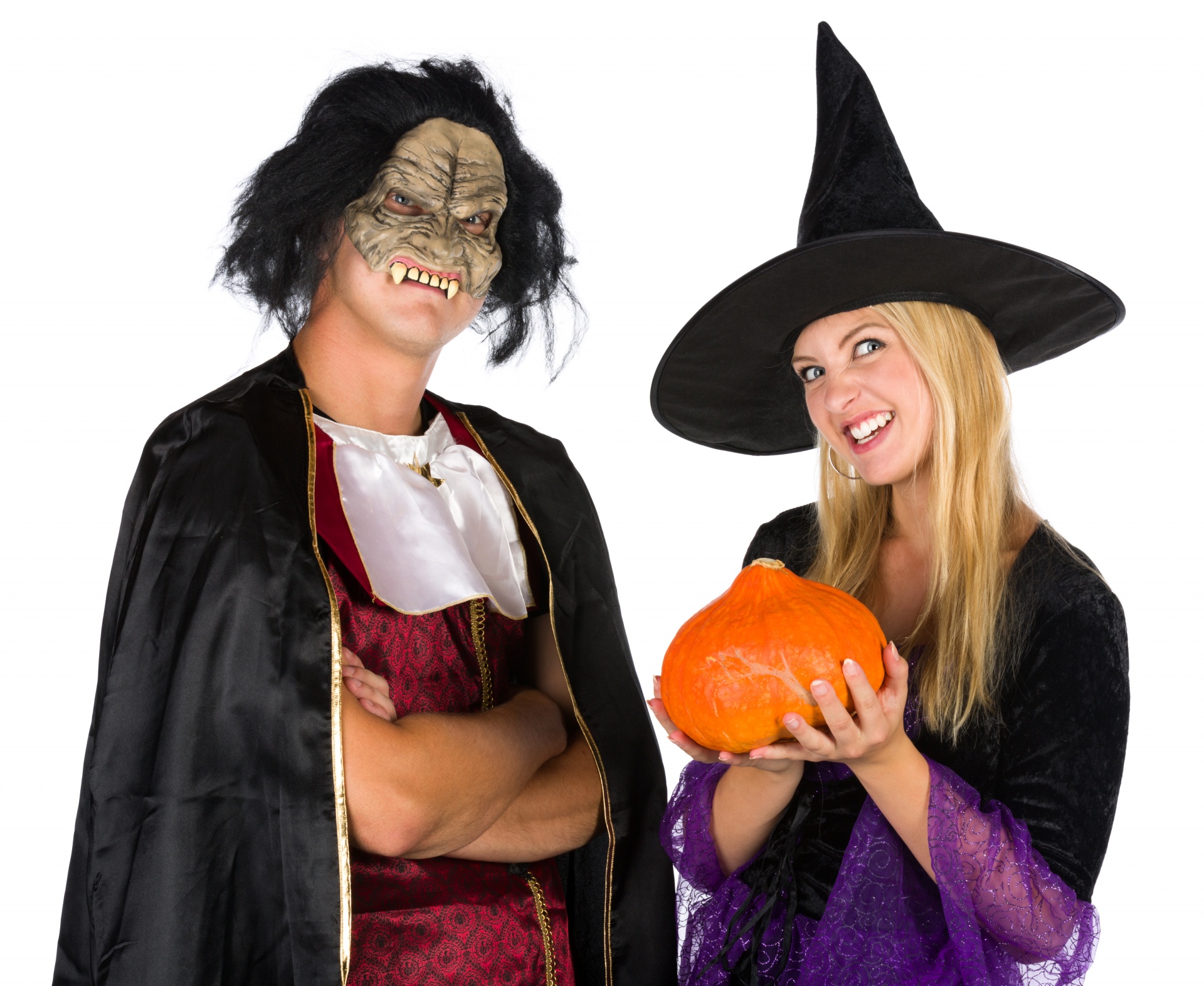 Young couple in a vampire and a witch Halloween costumes
