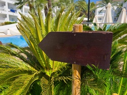 Blank wooden arrow in a holiday hotel resort