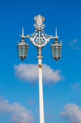 Decorative lamp post against blue sky
