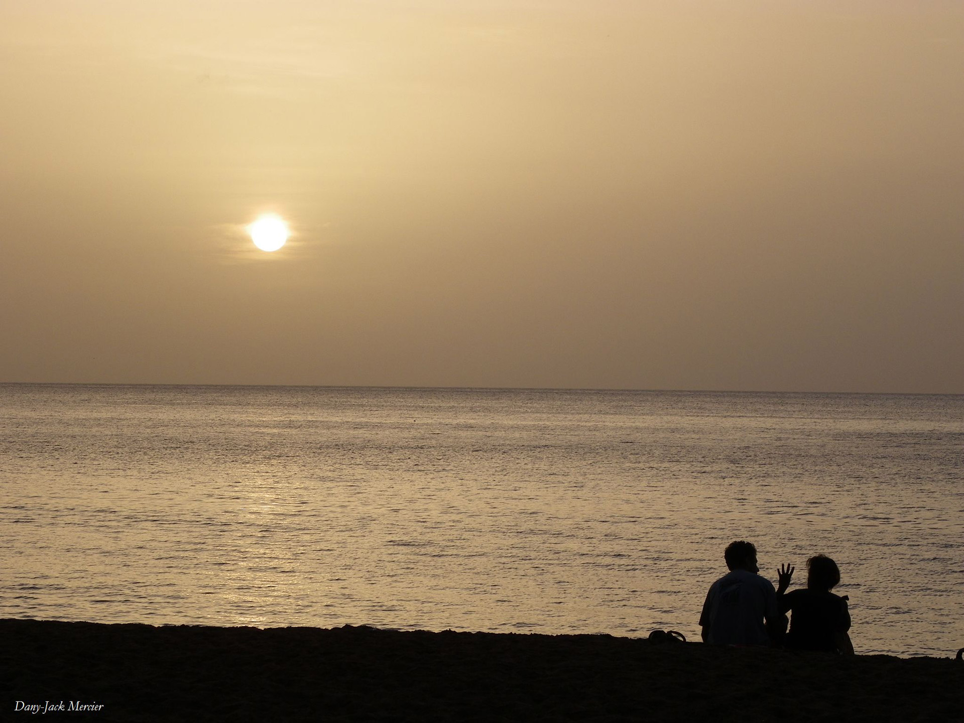 Two lovers in the evening on the beach of Deshaies in Guadeloupe