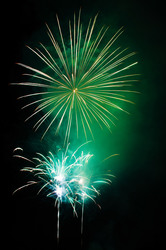 Green fireworks explosion on dark background