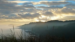 The joy of mountain hiking - seeing sunrise over the coast. Shot in northern Taiwan.