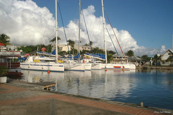 1999 photo showing boats in the marina at Pointe-Ã -Pitre and ominous dark clouds behind