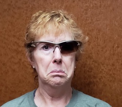 Funny picture of a woman looking sad because one side of her sunglasses broke