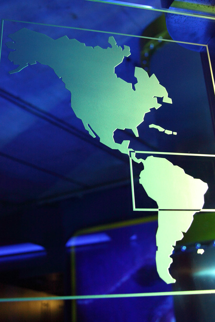 North and south america on blue glass board