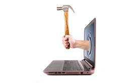 Hand holding hammer and comes from the laptop screen, isolated on the white background