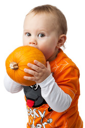 Halloween boy holding a pumpkin isolated on white background