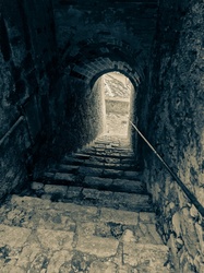 Old dark stone staircase in a castle