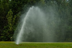 Watering golf course grass field