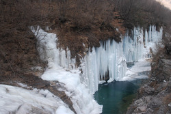 Mountain springs freeze creating ice waterfalls