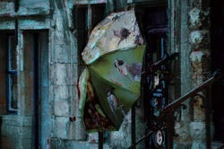 An artistic rendering of a photograph of a large umbrella hanging to dry