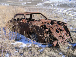 Abandoned Car in the Grasslands in the early spring