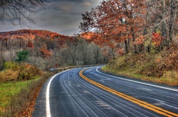A bend in the road in autumn scenery