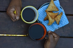 An African couple enjoying a cup of coffee in the morning.