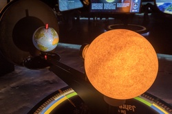 A museum exposition of how the sun illuminates planet Earth during a year and a day