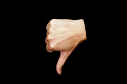 Thumb down isolated on black