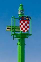 Coat of arms of Croatia on a pole in a harbor