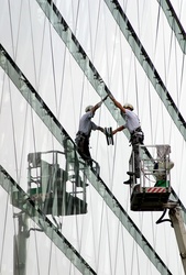 The window cleaner is washing the office block window