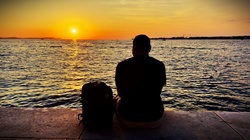 Solo traveller watching the sunset in Croatia