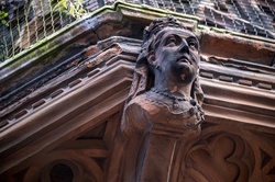 Sculpture of the head of a man on the corner of a historic building in Belfast, Northern Ireland