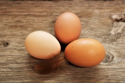 Three Brown Eggs On Wood Table