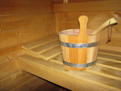 Wooden bucket in hot sauna