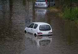 Flooded road and broken down cars
