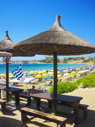 Straw umbrellas on beach in Cyprus