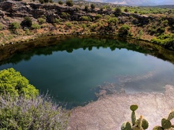 Limestone sinkhole filled with underground spring water - Montezuma Well in Arizona