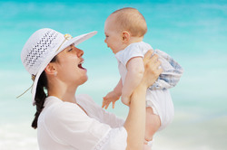 Mom and baby having fun on the beach