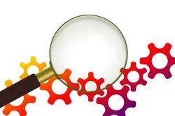 Magnifying glass in front of gears