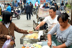 Buying fresh baked bread on street