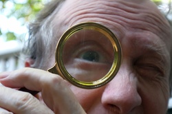 Man looking with magnifying glass