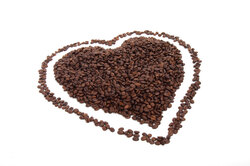 Heart shape made with coffee beans isolated on white background