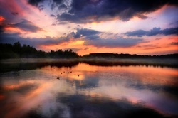 Water mirroring sunset on lake photography