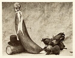 This old tramp is made from a banana; his fire being a few filbert nuts; his hat a blackened cork on a small circular card.