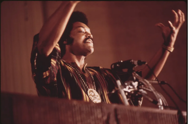 The Rev. Jesse Jackson speaks on a radio broadcast from the headquarters of Operation