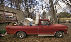 Old truck loaded with trash.