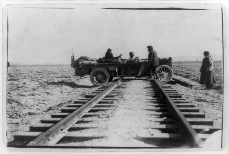 Automobile Straddling Railroad Tracks During a Race Between New York and San