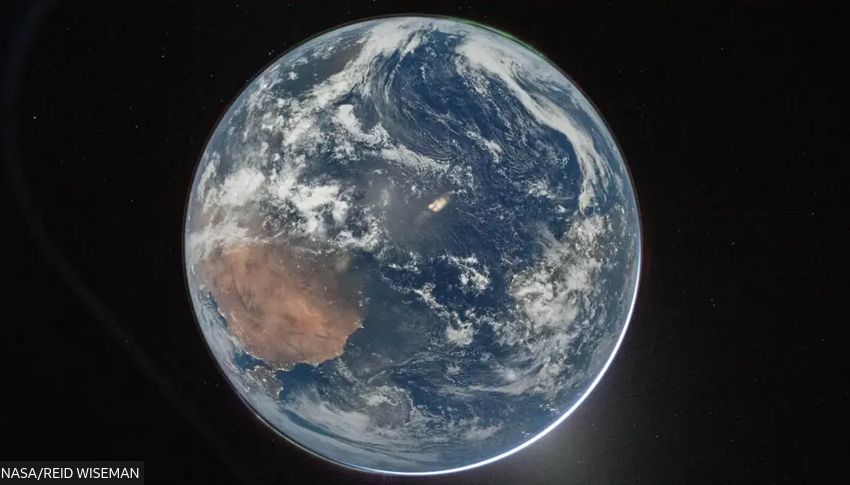 The image, titled Hello, World, shows the Earth as seen from the Orion capsule