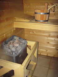 Bucket and stones in hot sauna
