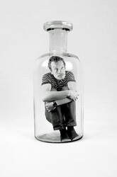 Sad man trapped inside bottle